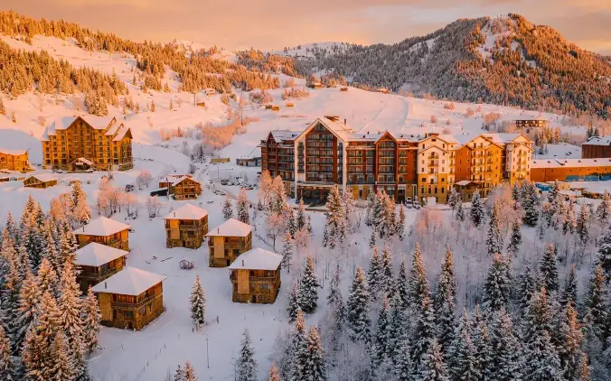 Goderdzi Ski Resort at sunset — snowy slopes and chalets bathed in golden light in the Adjara mountains