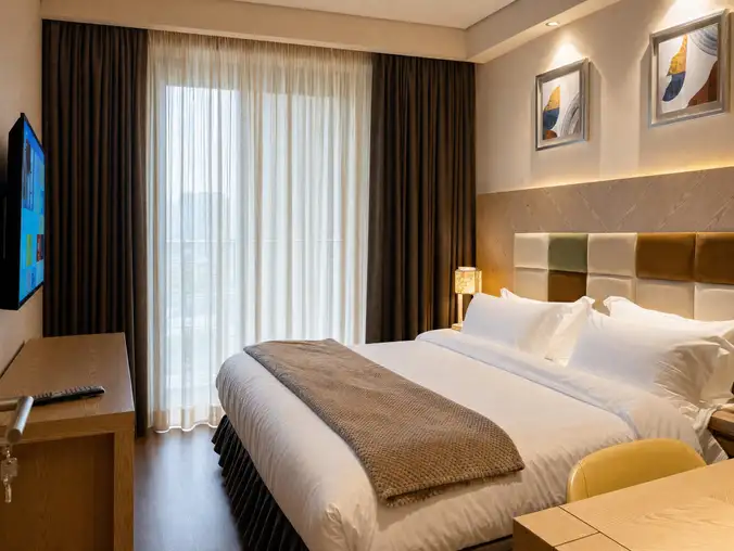 One Bedroom Sea View & Mountain — Separate bedroom with king-size bed and sheer curtains in daylight One Bedroom Sea View & Mountain — Separate bedroom with king-size bed and sheer curtains in daylight