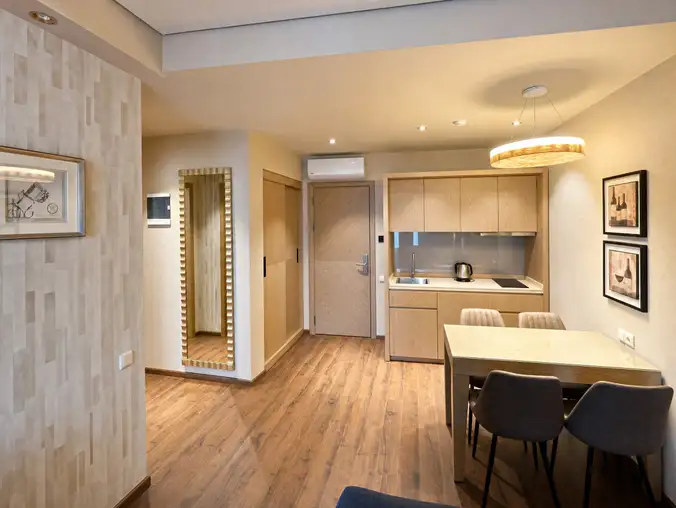 One Bedroom Sea View & Mountain — Kitchenette and dining area near the entry with full-length mirror One Bedroom Sea View & Mountain — Kitchenette and dining area near the entry with full-length mirror