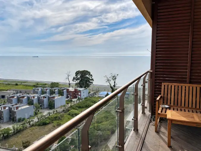 One Bedroom Sea View & Mountain — Wooden balcony bench with calm Black Sea view from the apartment One Bedroom Sea View & Mountain — Wooden balcony bench with calm Black Sea view from the apartment