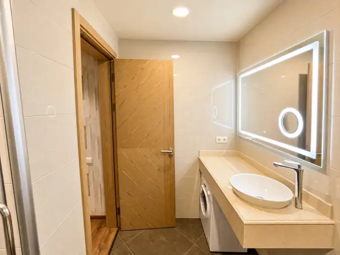 One Bedroom Sea View & Mountain — Bathroom with vessel sink, LED mirror and built-in washing machine One Bedroom Sea View & Mountain — Bathroom with vessel sink, LED mirror and built-in washing machine