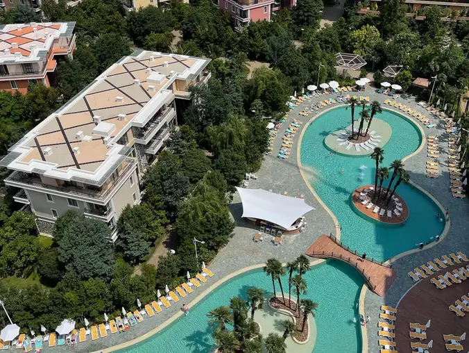 One Bedroom Sea Front & Pool View — Aerial view of resort pools and aquapark from the balcony