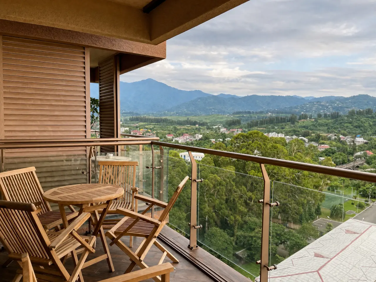 Wooden terrace seating with mountain panorama at golden hour